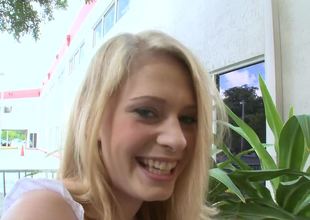 Blonde has a wide smile on their way face as A she sucks a big pole